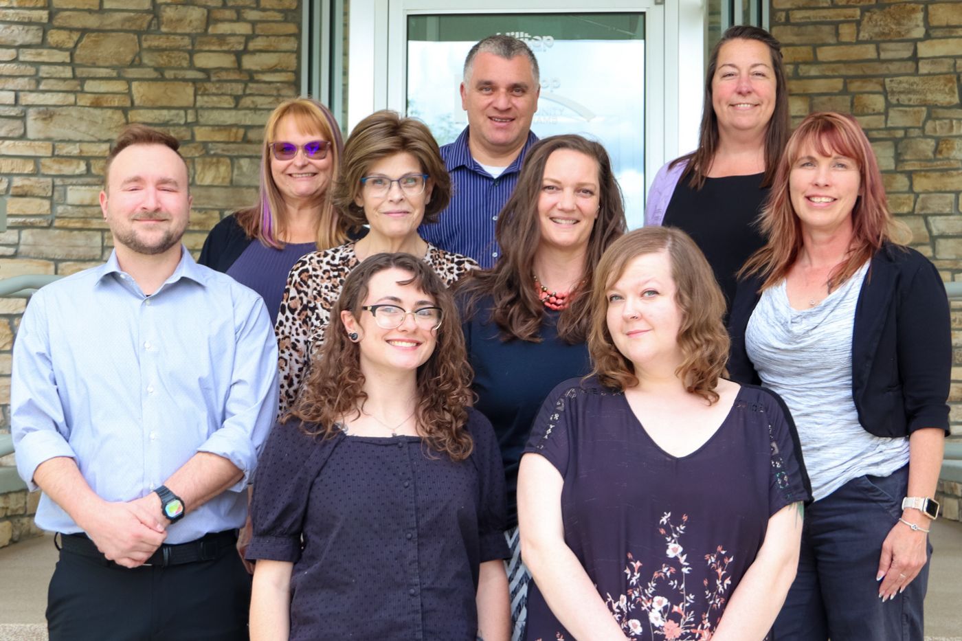 Group of therapists smiling on steps of building