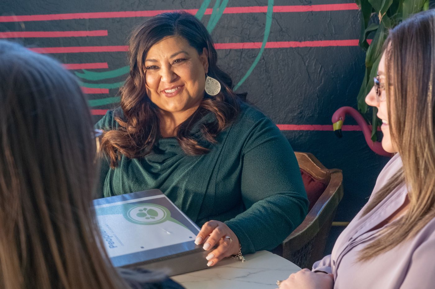 Woman at table with binder smiling
