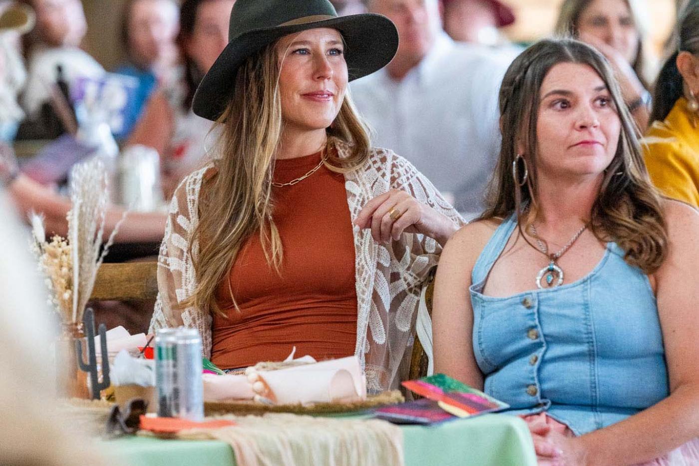 Two women in dining room looking at stage
