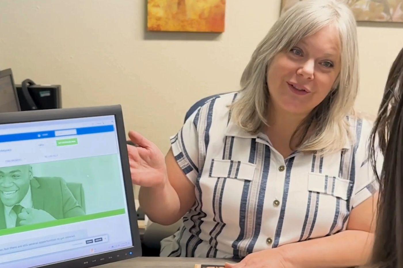 Woman going over computer screen with client