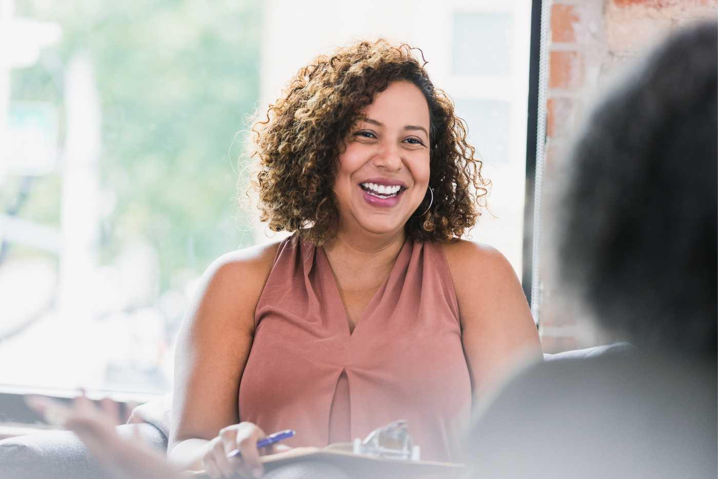 Woman holding clipboard and smiling