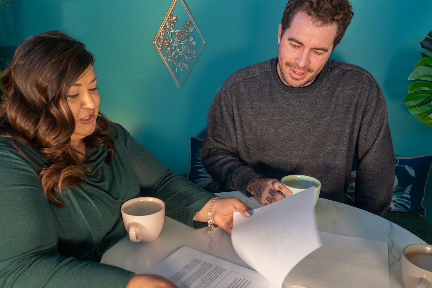 Woman going over paperwork with man