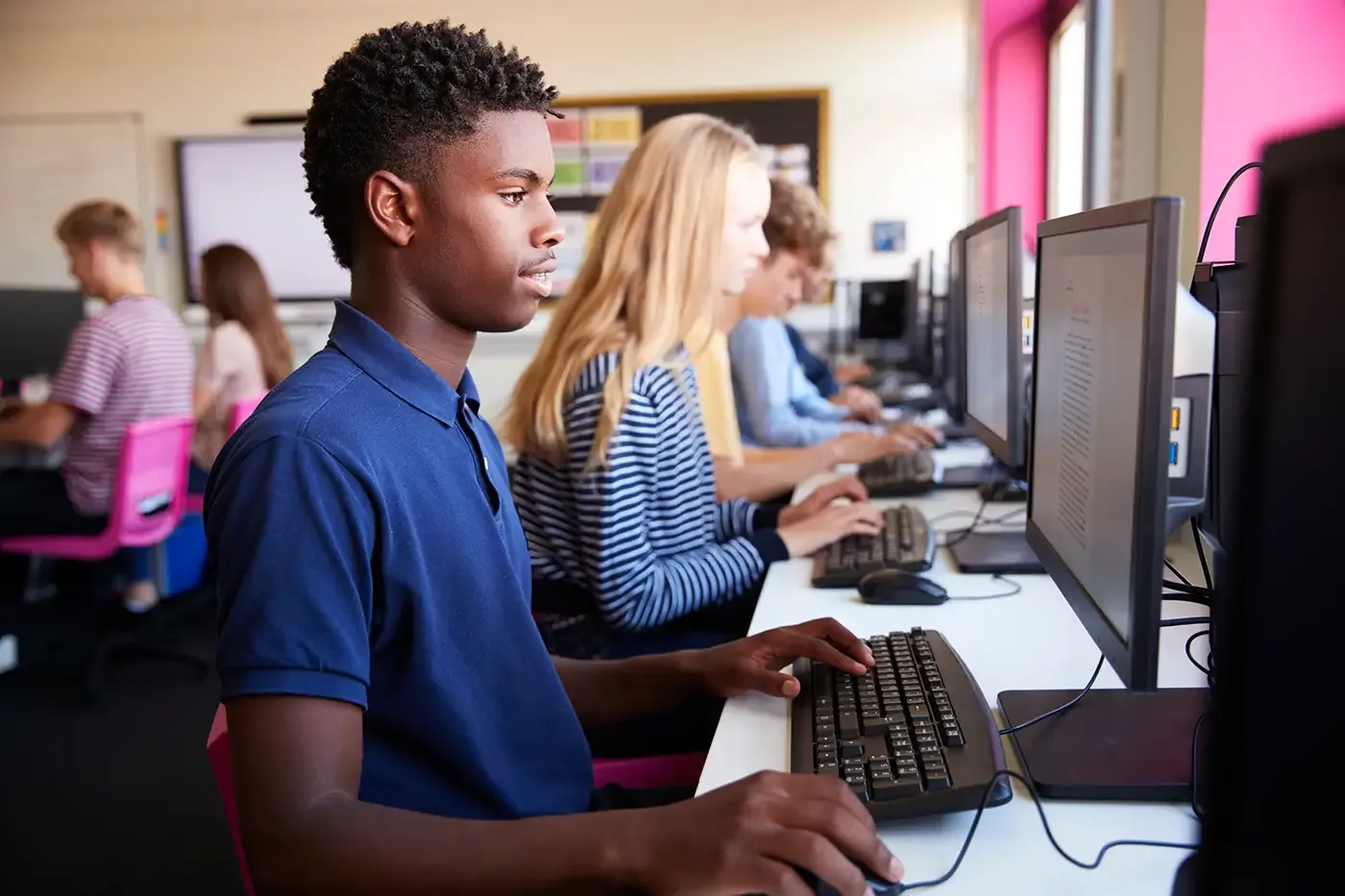 Students working at computers in a classroom, reflecting Balanced Rock Community School’s supportive, trauma-informed environment that helps young people build confidence, continue their education, and gain practical life skills.